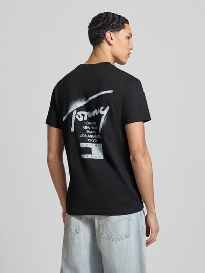 Männermodel trägt Regular Fit T-Shirt aus reiner Baumwolle von Tommy Jeans, Optik: Unifarben, Label-Print, Ganzkörperansicht Rückansicht.