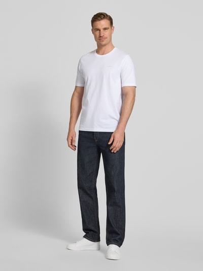 Männermodel trägt T-Shirt mit Label-Detail von bugatti in Weiß, reine Baumwolle, gerader Schnitt, Rundhalsausschnitt, Ganzkörperansicht von vorne.