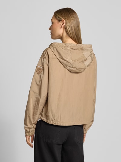 Frauenmodel trägt Trekking Jacke mit Kapuze Modell 'BURRAGE' von Blauer Usa in Beige, gerader Schnitt, Rückenansicht, Detailaufnahmen.