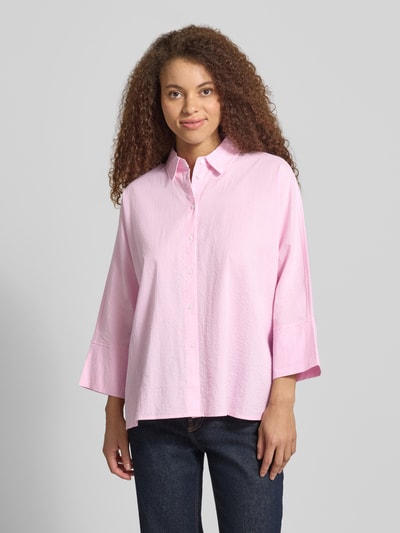 Frauenmodel trägt Boxy Fit Bluse aus reiner Baumwolle Modell 'AUGUSTA' von Only mit Allover-Muster, Kimonoärmel, Hemdkragen, gestreift, einreihige Knopfleiste, Twillgewebe, zartrosa-weiß, Ganzkörperansicht von vorne.