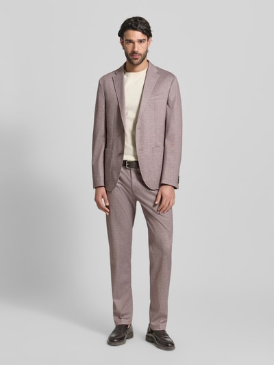 Męski model nosi Straight Fit Anzughose mit Viskose-Anteil Modell 'Rick' od Pierre Cardin, jasnoróżowy, proste nogawki, przód z kantem, widok całej sylwetki z przodu, elastyczny materiał, kieszenie z tyłu, szerokość w rozmiarze 50: 39 cm, długość nogawki wewnętrznej: 81 cm.