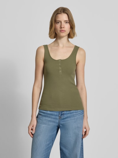 Frauenmodel trägt Slim Fit Tank Top aus Bio-Baumwoll-Mix Modell 'KITTE' von Pieces in Optik: Unifarben mit Knopf-Detail, Rippstruktur, Henley-Ausschnitt und breite Träger; Ganzkörperansicht von vorne.