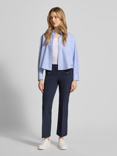 Frauenmodel trägt dunkelblaue Flared Fit Stoffhose mit Pattentaschen Modell 'Farah' von Cambio, elastischer Material-Mix, Ganzkörperansicht von vorne.