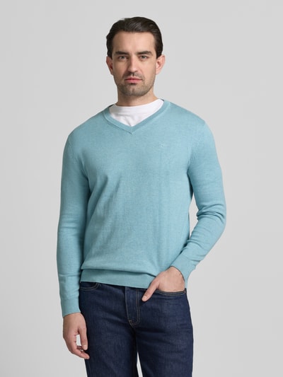 Mannenmodel draagt Regular Fit Pullover aus reiner Baumwolle van Tom Tailor, effen lichtblauw, fijngebreid katoen, logo-stiksel, lange mouwen, geribbelde boorden, V-hals, crew neck, vooraanzicht van het hele lichaam.