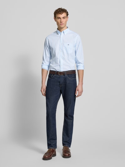 Männermodel trägt Slim Fit Freizeithemd mit Brusttasche von Gant, hellblau gestreift, Baumwolle, Button-Down-Kragen, Ganzkörperansicht von vorne