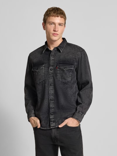 Männermodel trägt Relaxed Fit Jeanshemd mit Brusttaschen Modell 'WESTERN' von Levi's®, reine Baumwolle, schwarze Waschung, Nahaufnahme Oberkörper.