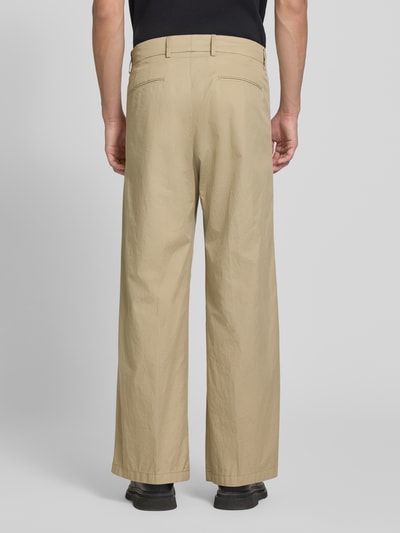Männermodel trägt Stoffhose mit Biesen und Eingrifftaschen Modell 'LEEK' von Drykorn aus Reine Baumwolle, Wide-Fit, Ganzkörperansicht Rückansicht