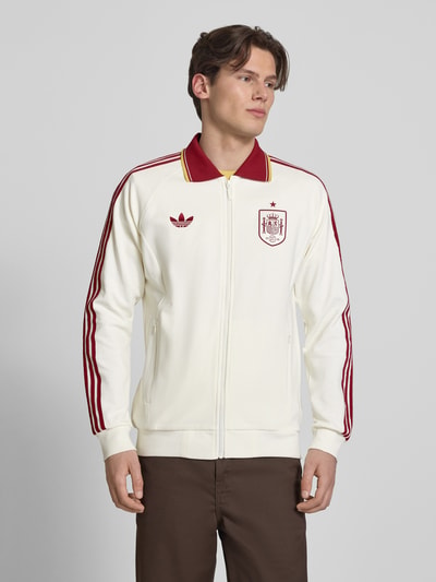 Männermodel trägt Regular Fit Trainingsjacke aus Baumwoll-Mix Modell 'BLACAS' von adidas Sportswear, Optik: Unifarben, Struktur, Kontraststreifen, Logo-Stitching, Umlegekragen, Langarm, Reißverschluss, Eingrifftaschen, Vorderansicht, Nahaufnahme Oberkörper.