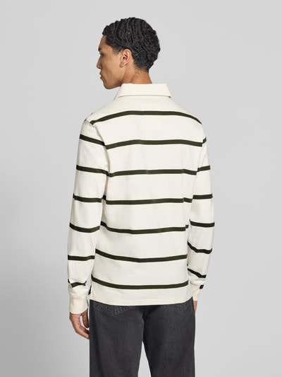 Männermodel trägt Poloshirt aus reiner Baumwolle von Superdry in Creme mit grünen Streifen, gerader Schnitt, Rückenansicht, Ganzkörperansicht Rückansicht.