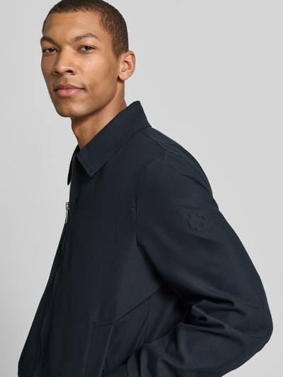 Mężczyzna nosi Regular Fit Blouson mit Umlegekragen Modell 'LIGHT 2.0' od Strellson, jednolity kolor, zamek, długie rękawy, napoleońska kieszeń, widok z przodu półzbliżenie.