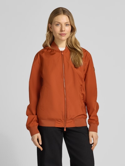 Frauenmodel trägt Jacke mit Zweiwege-Reißverschluss Modell 'OLEN' von SAVE THE DUCK in Orange, Material-Mix mit Stretch, Regular Fit, Stehkragen, Ganzkörperansicht von vorne.