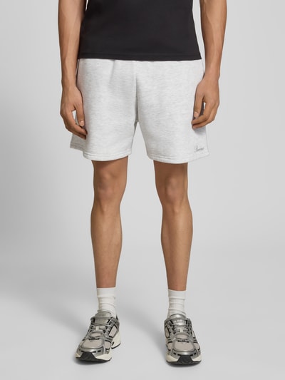 Männermodel trägt Shorts mit Gesäßtasche und Logo-Stitching von REVIEW, Baumwoll-Mix, Gerader-Schnitt, Kordelzug, Eingrifftaschen, Ganzkörperansicht von vorne.