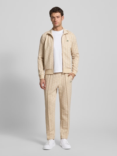 Männermodel trägt Regular Fit Sweatjacke mit Baumwoll-Anteil von Lacoste in Optik: Unifarben, Allover-Muster, Logo-Patch, Ganzkörperansicht von vorne.
