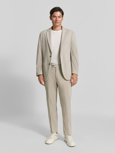 Männermodel trägt Straight Fit Hose in Cord-Optik von Christian Berg Men in Beige mit Bügelfalten, Gesäßtaschen, Ganzkörperansicht von vorne.