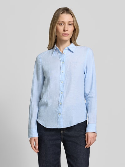 Modelka kobieca nosi Regular Fit Leinenbluse mit Label-Stitching von Gant, czysty len, krój regular fit, kołnierzyk koszulowy, wyhaftowane logo, listwa guzikowa, długość tyłu w rozmiarze 36: 66 cm, długość rękawów w rozmiarze 36: 60 cm, jasnoniebieski kolor, gładka faktura, widok całej sylwetki z przodu.