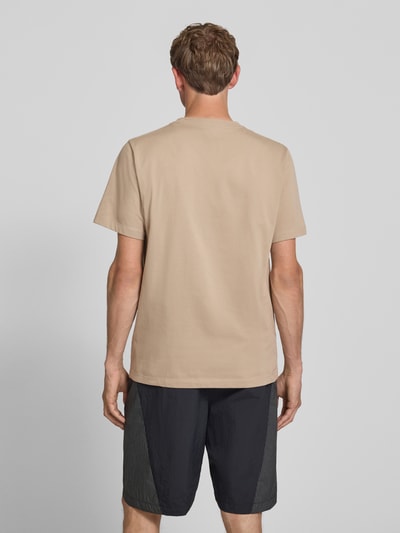 Männermodel trägt T-Shirt mit Label-Stitching und Rundhalsausschnitt von The North Face, Baumwoll-Mix, Regular-Fit, Rückenlänge 72 cm, Ganzkörperansicht Rückansicht.