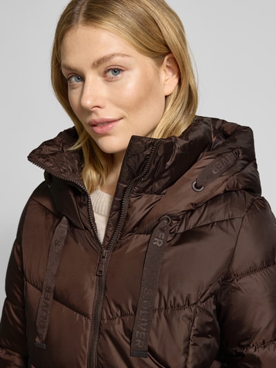 Frauenmodel trägt Regular Fit Steppjacke mit Kapuze von s.Oliver CASUAL in Braun, unifarben, Nahaufnahme Oberkörper.