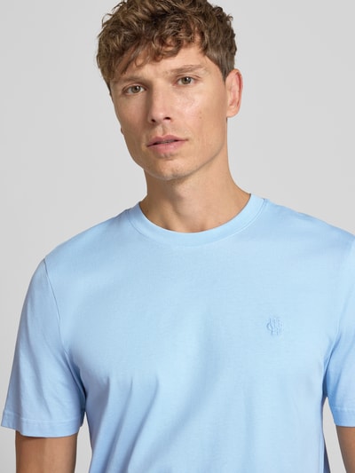 Męski model nosi Regular Fit T-Shirt mit Logo-Stitching von MCNEAL z bawełny, okrągły dekolt, kolor jasnoniebieski, długość tyłu 70 cm, rozmiar M, zbliżenie na górną część ciała.