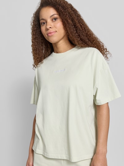 Frauenmodel trägt Oversized Damen T-Shirt aus Reine Baumwolle von Pegador, Modell 'BRACY' mit Label-Stitching und Rundhalsausschnitt, Rückenlänge bei Größe S 62 cm, Ganzkörperansicht von vorne.