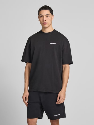 Męski model nosi Oversized T-Shirt mit Logo-Stitching von Pegador z bawełny, krój oversized fit, okrągły dekolt, długość tyłu 73 cm, Ganzkörperansicht von vorne.