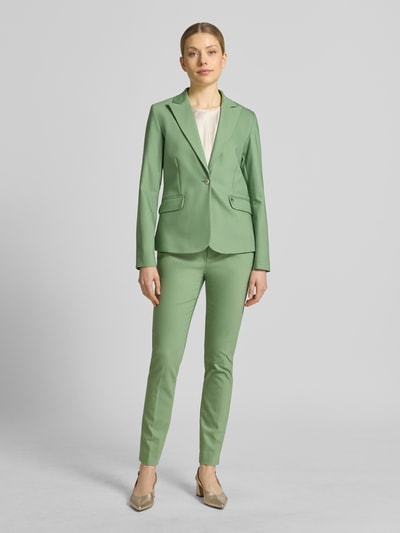 Vrouwenmodel draagt Regular Fit Blazer met klepzakken model 'Blake' van MOS MOSH in katoenmix met stretch en reverskraag, regular fit, knoopsluiting, klepzakken, ruglengte maat 36: 61 cm, borstwijdte 46 cm, mouwlengte 63 cm, geheelopname voorkant.