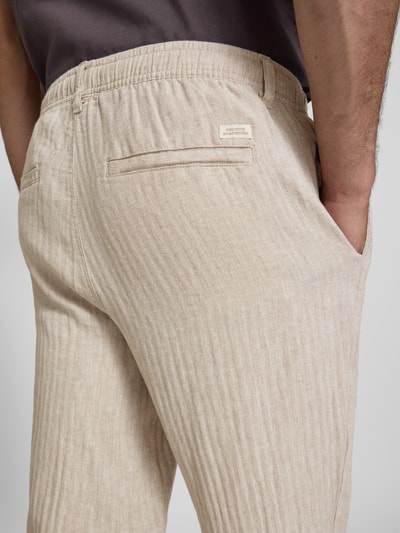 Männermodel trägt HOSE aus Leinen-Baumwoll-Mix Modell 'MAXIM' von Blend in Beige mit Elastikbund, Nahaufnahme Rückansicht, Relaxed-Fit, Bundweite bei Größe M 42 cm, Innenbeinlänge 78 cm.