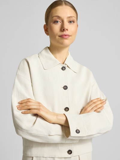 Vrouwenmodel draagt Loose Fit Hemdjacke aus Viskose-Leinen-Mix van Marc O'Polo, effen kleuren, platte kraag, knoopsluiting, mix van viscose en linnen, twill, lange mouw, elastische rompzoom, klepzakken, korte lengte, nahaufnahme bovenlichaam.