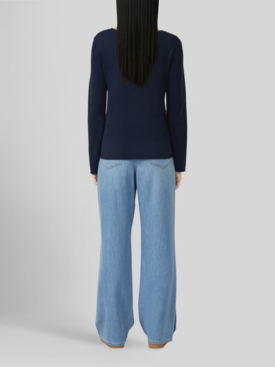 Frauenmodel trägt Regular Fit Pullover aus Baumwoll-Viskose-Mix von s.Oliver RED LABEL in Dunkelblau, kombiniert mit hellblauer Jeans, Ganzkörperansicht Rückansicht.