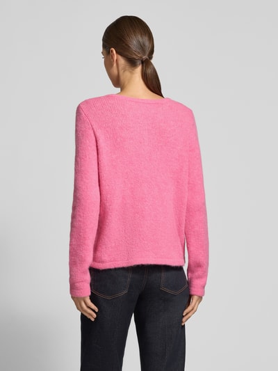 Vrouwenmodel draagt Strickjacke mit Rundhalsausschnitt und Knopfleiste van Milano Italy in roze, regular fit, opgestikte zakken, ruglengte 48 cm, mouwlengte 62 cm, ganzlichaamsaanzicht achteraan.