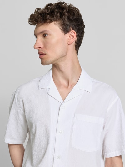Männermodel trägt Modern Fit Freizeithemd mit Brusttasche Modell 'BLASHAWN' von Jack & Jones Premium, Baumwoll-Mix, Strukturmuster, Nahaufnahme Oberkörper.