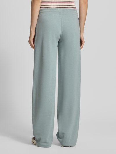 Vrouwenmodel draagt Straight Fit Sweatpants met tunnelkoord van REVIEW in lichtblauwe katoenmix, straight fit, elastische band, binnenbeenlengte maat S 85 cm, geheel van achteren