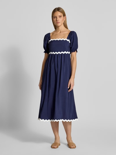 Frauenmodel trägt Tunikakleid mit Karree-Ausschnitt von Apricot in Dunkelblau mit weißer Zierborte, A-Linie, Midikleid, 1/2-Arm, elastische Ärmelabschlüsse, Rückenlänge bei Größe S: 120 cm, Brustweite bei Größe S: 40 cm, Ärmellänge bei Größe S: 30 cm, Ganzkörperansicht von vorne.