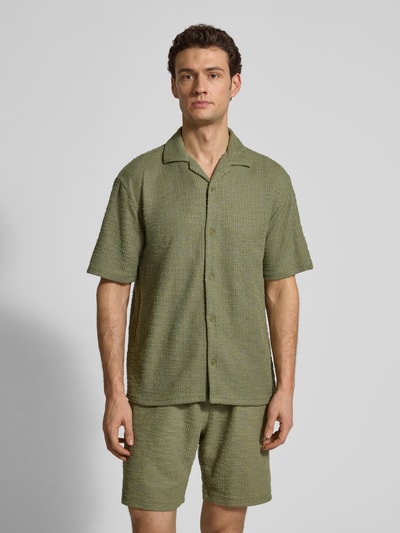 Männermodel trägt Regular Fit Freizeithemd mit Strukturmuster von MCNEAL in Grün, Elastischer-Material-Mix, Kurzärmelig, Ganzkörperansicht von vorne.