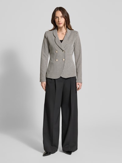 Frauenmodel trägt Slim Fit Blazer mit Reverskragen von Emporio Armani, creme-schwarzes Muster, elastischer Materialmix, Ganzkörperansicht von vorne.