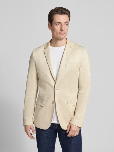 Męski model nosi Slim Fit Sakko mit Reverskragen od Antony Morato, mieszanka materiałów z dodatkiem streczu, kieszenie z patką, zapięcie na guzik, długość tyłu w rozmiarze 50: 72 cm, szerokość ramion w rozmiarze 50: 45 cm, długość rękawów w rozmiarze 50: 67 cm, jasny beż, gładka tekstura, krój slim fit, widok całej sylwetki z przodu.