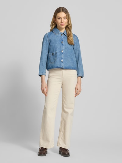 Frauenmodel trägt Regular Fit Jacke in Denim-Optik von Bash aus Reiner Baumwolle mit Umlegekragen, aufgesetzter Tasche und Knopfleiste, Ganzkörperansicht von vorne.