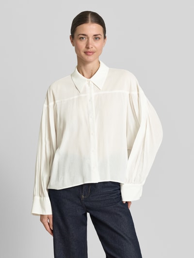 Frauenmodel trägt Relaxed Fit Bluse Modell 'SELENI' von Drykorn in Creme, Baumwoll-Viskose-Mix, Hemdblusenkragen, Knopfleiste, Ganzkörperansicht von vorne.