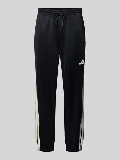 Produktfoto, Sweatpants mit elastischem Bund von adidas Sportswear aus Material-Mix mit Baumwoll-Anteil, lockerem Schnitt, Tunnelzug, Label-Print und Eingrifftaschen, Farbe Schwarz mit weißen Details, Innenbeinlänge 72 cm bei Größe M.