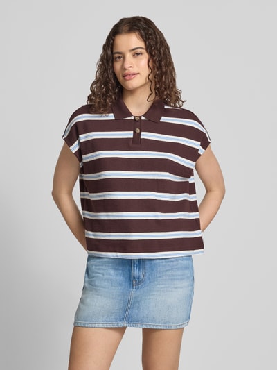 Frauenmodel trägt Regular Fit Poloshirt aus reiner Baumwolle von Marc O'Polo DENIM in Braun mit weißen und blauen Streifen, Ganzkörperansicht von vorne.