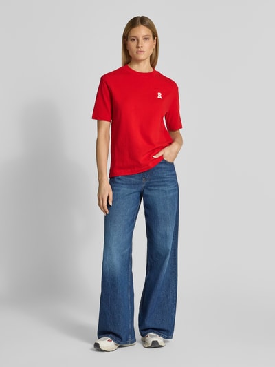 Modelka nosi damski t-shirt Loose Fit T-Shirt aus reiner Baumwolle Modell 'ICONIC A TARJAA' od Armedangels w efekcie jednolity kolor, z wyhaftowanym logo, okrągłym dekoltem, krótkim rękawem, wykonany z drobno prążkowanej, czystej bawełny; zdjęcie: widok całej sylwetki z przodu.