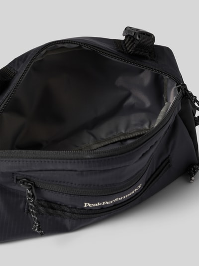 Produktfoto, czarna Fahrradtasche mit Label-Detail von PEAK PERFORMANCE, główna przegroda z zamkiem błyskawicznym, boczna przegródka, regulowane paski, detal z logo, szerokość w rozmiarze 1: 26 cm, długość w rozmiarze 1: 14 cm, głębokość w rozmiarze 1: 5 cm, długość paska: 94 cm