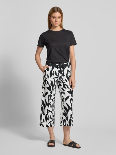 Frauenmodel trägt Culotte aus Leinen-Baumwoll-Mix mit Gürtel von Christian Berg Woman im Allover-Look, schwarz-weiß, Ganzkörperansicht von vorne.
