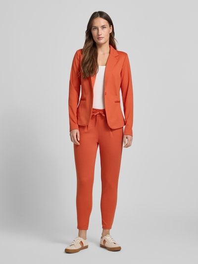 Frauenmodel trägt Stoffhose mit elastischem Bund Modell 'KATE' von ICHI, Material-Mix mit Viskose-Anteil, Gerader-Schnitt, orange, Ganzkörperansicht von vorne