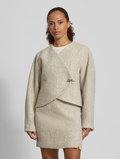Frauenmodel trägt Blazer in Bouclé-Optik mit Woll-Anteil von Oui, cremefarben, gerade Passform, Label-Detail, Ganzkörperansicht von vorne. Damen Blazer von Bouclé-Optik, Material-Mix, Rückenlänge 50 cm, Brustweite 52 cm, Ärmellänge 62 cm.