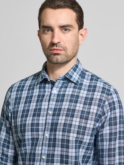 Männermodel trägt Regular Fit Business-Hemd mit Kentkragen von Jake*s aus Leinen-Baumwoll-Mix, kariert, Nahaufnahme Oberkörper. Rückenlänge 76 cm, Schulterbreite 46 cm, Ärmellänge 65 cm, Knopfleiste, Sportmanschetten und abgerundeter Saum.