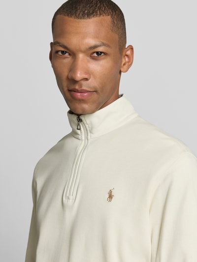 Männermodel trägt Regular Fit Sweatshirt aus Baumwoll-Mix von Polo Ralph Lauren in Creme mit Reißverschluss, Nahaufnahme Oberkörper.