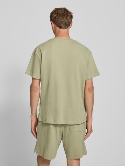 Männermodel trägt Henley-Shirt mit Strukturmuster und Label-Stitching von BLKVIS in Grün, Reine Baumwolle, Regular-Fit, Rückenlänge 72 cm, Ganzkörperansicht Rückansicht.