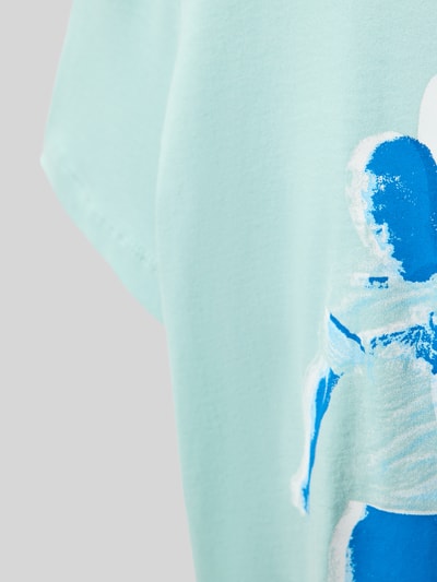 Mädchen trägt Regular Fit T-Shirt aus reiner Baumwolle von s.Oliver RED LABEL, Optik: Unifarben, Motiv-Print, Nahaufnahme Oberkörper.