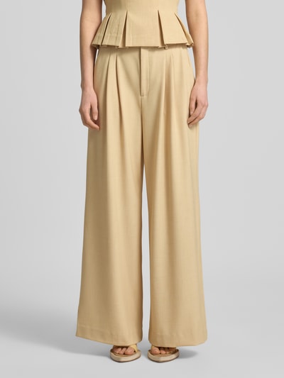 Kobiece model nosi spodnie Loose Fit Pants mit Eingrifftaschen Modell 'stacy' von Gestuz, mieszanka materiałów z dodatkiem wiskozy, krój loose fit, zapięcie na guzik i zamek błyskawiczny, wpuszczane kieszenie, z tyłu kieszeń z wypustką, szerokość w rozmiarze 36: 38 cm, długość wewnętrzna nogawki 78 cm, jasnobeżowy kolor, gładka faktura, widok na całe ciało z przodu.