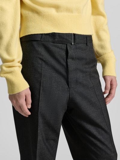Männermodel trägt Anzughose aus Viskose-Mix von Officine Générale in Schwarz mit Bügelfalten und integriertem Gürtel, Nahaufnahme Oberkörper. Straight Fit, Gesäßtaschen, Innenbeinlänge 76 cm, Bundweite 46 cm.